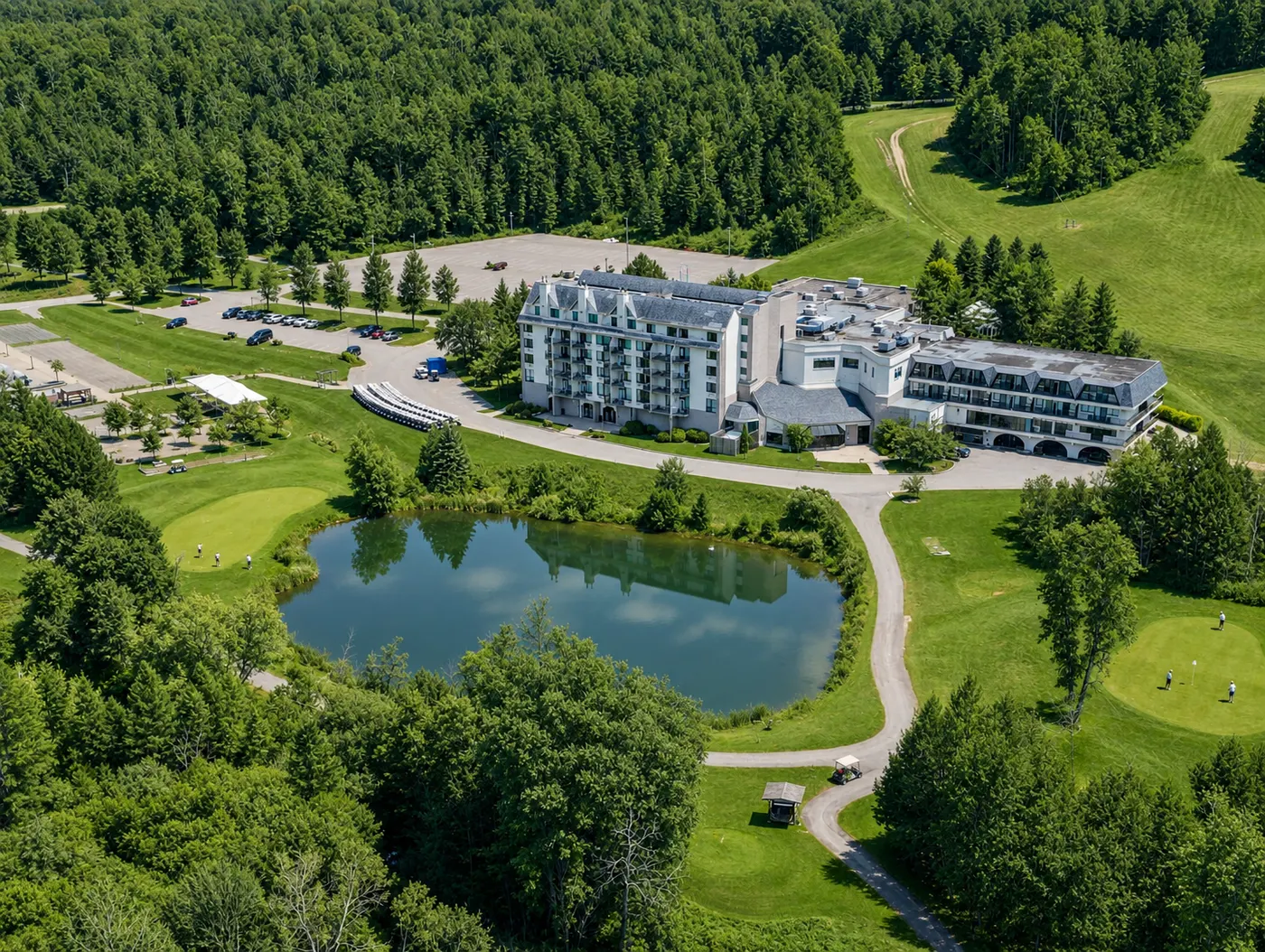Aerial view of Hockley Valley Resort, showing the hotel, the pond and golf greens surrounded by dense forest.